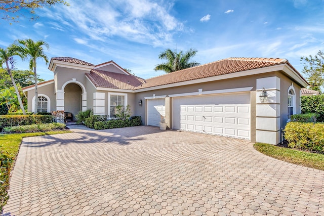 mediterranean / spanish-style home featuring a garage