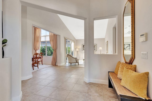 tiled foyer entrance featuring lofted ceiling