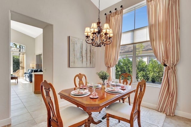 tiled dining area featuring plenty of natural light and a chandelier