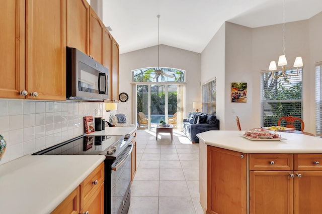 kitchen with vaulted ceiling, pendant lighting, decorative backsplash, light tile patterned floors, and electric stove