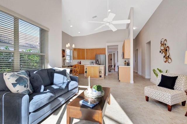 tiled living room with high vaulted ceiling and ceiling fan