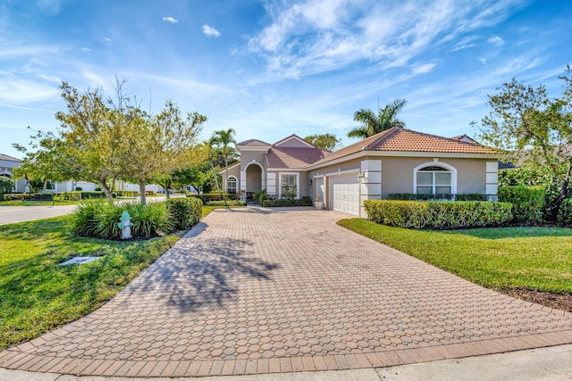 mediterranean / spanish-style home featuring a garage and a front lawn