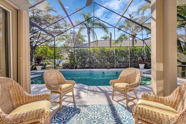 view of swimming pool with a patio and glass enclosure