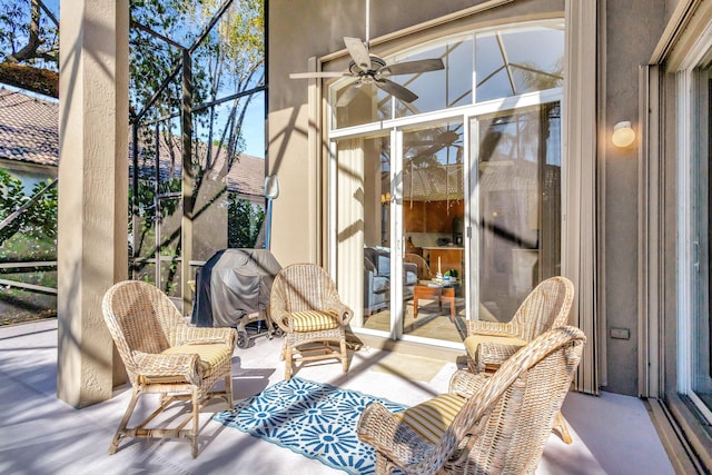 sunroom / solarium with ceiling fan and a healthy amount of sunlight