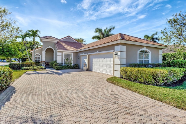 mediterranean / spanish-style home featuring a garage