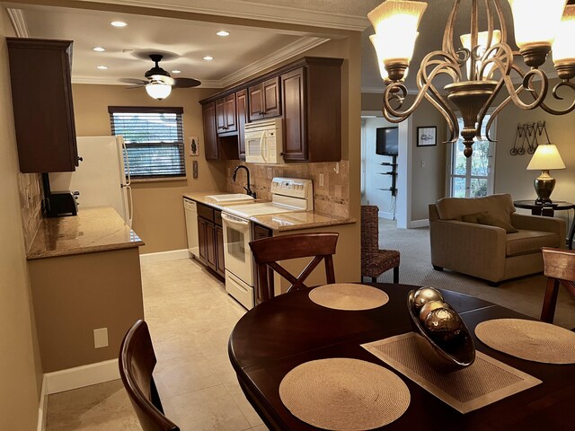 1292 High Point Pl S Unit B, Delray Beach, FL 33445 - kitchen with white appliances, a sink, crown molding, dark brown cabinetry, and backsplash