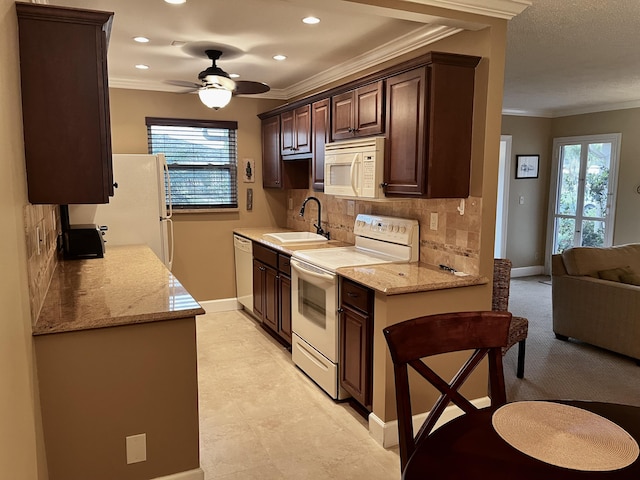 1292 High Point Pl S Unit B, Delray Beach, FL 33445 - kitchen with white appliances, a sink, dark brown cabinets, baseboards, and crown molding