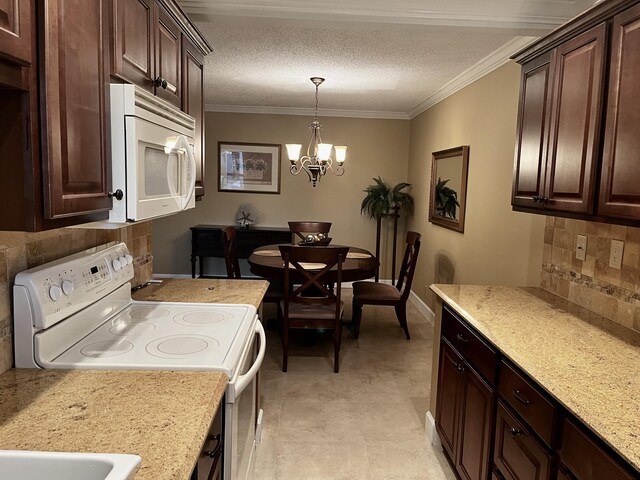 1292 High Point Pl S Unit B, Delray Beach, FL 33445 - kitchen with white appliances, tasteful backsplash, dark brown cabinets, a chandelier, and crown molding