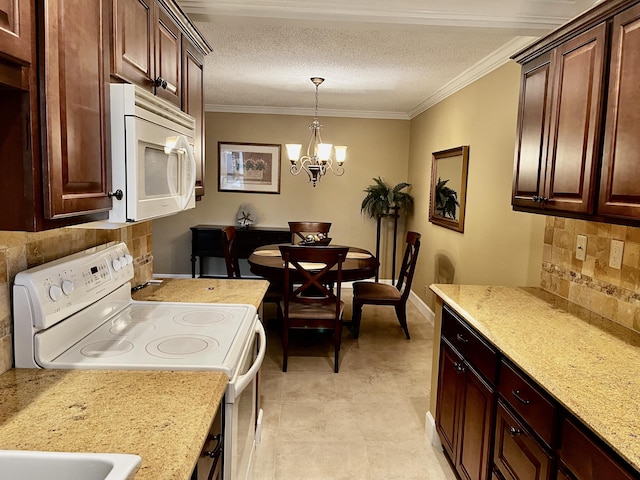 1292 High Point Pl S Unit B, Delray Beach, FL 33445 - kitchen with white appliances, backsplash, a chandelier, hanging light fixtures, and crown molding
