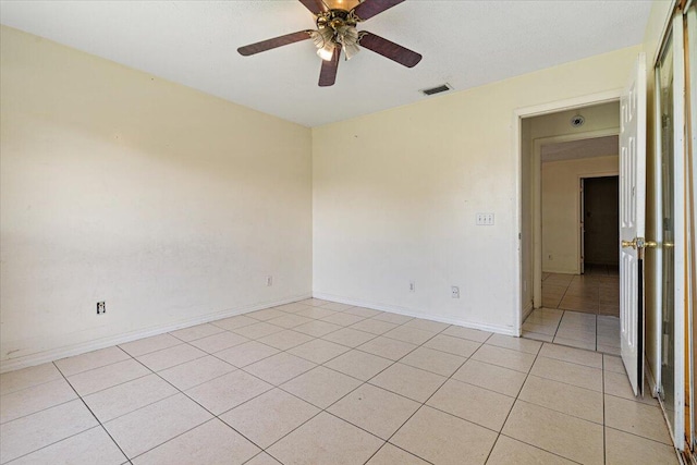 tiled empty room with ceiling fan