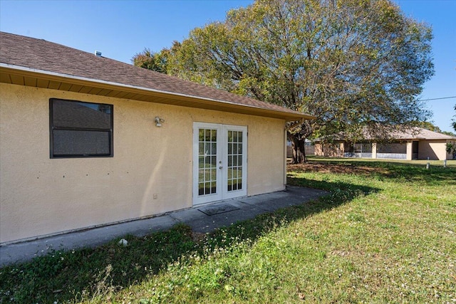 view of home's exterior featuring french doors and a yard