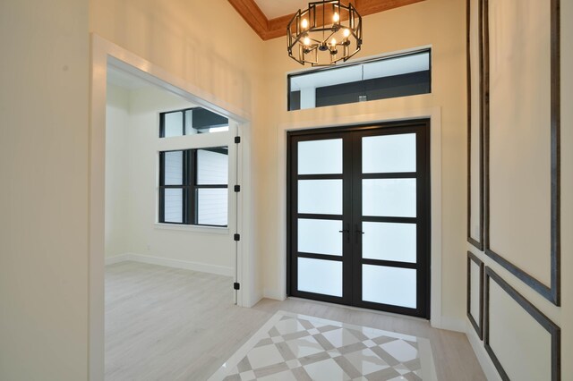 18202 Bridle Way, Fort Pierce, FL 34987 - foyer entrance with a chandelier, french doors, and light wood-type flooring