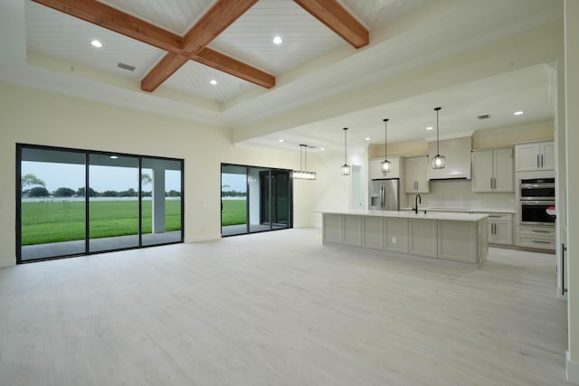 18202 Bridle Way, Fort Pierce, FL 34987 - unfurnished living room featuring beamed ceiling, recessed lighting, and light wood-style floors