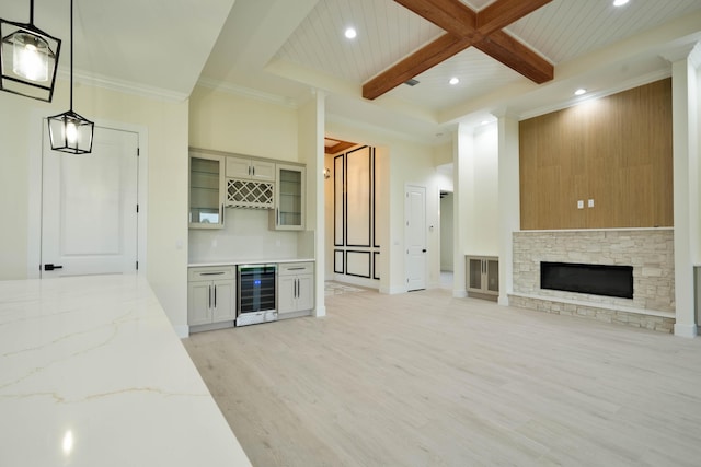 18202 Bridle Way, Fort Pierce, FL 34987 - unfurnished living room with beverage cooler, a bar, recessed lighting, light wood finished floors, and beamed ceiling