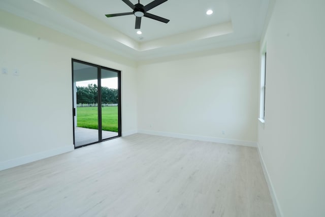 18202 Bridle Way, Fort Pierce, FL 34987 - empty room featuring light wood finished floors, ceiling fan, recessed lighting, and a raised ceiling