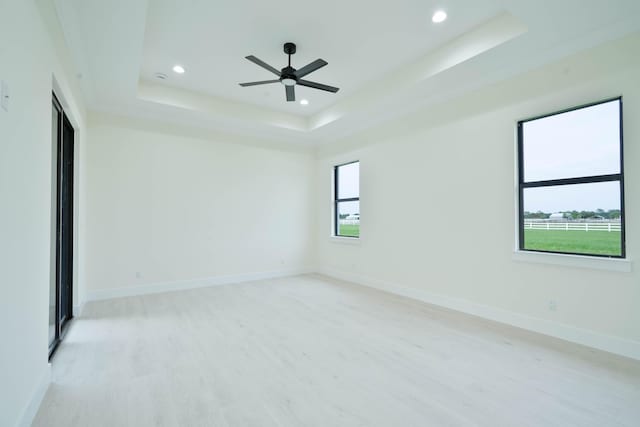 18202 Bridle Way, Fort Pierce, FL 34987 - unfurnished room with a raised ceiling, light wood-type flooring, recessed lighting, and a ceiling fan