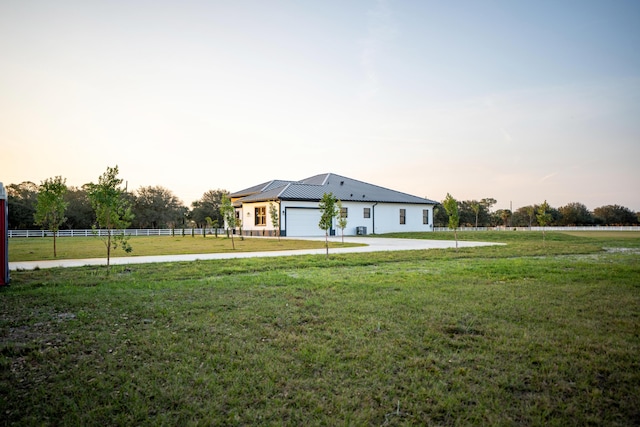 view of front facade with a garage and a lawn