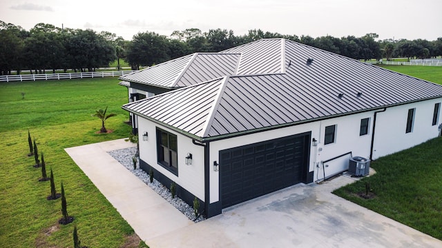 18202 Bridle Way, Fort Pierce, FL 34987 - view of front of house featuring a standing seam roof, a garage, stucco siding, and a metal roof