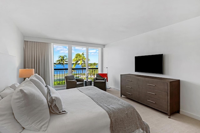 bedroom featuring light colored carpet and access to outside