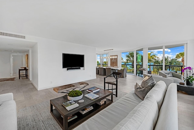 living room featuring expansive windows and light wood-type flooring