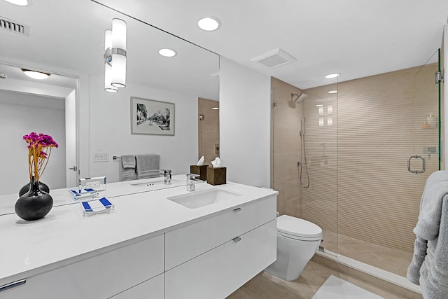 bathroom with vanity, an enclosed shower, and toilet