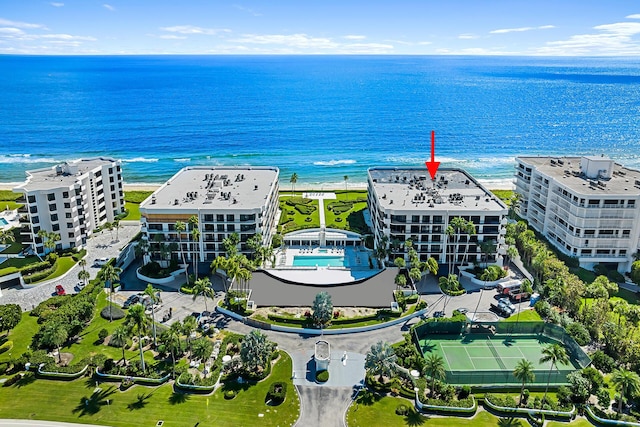 drone / aerial view with a water view and a beach view