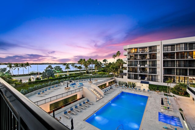 pool at dusk with a patio