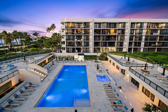 view of pool at dusk