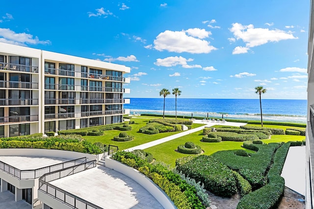 view of home's community featuring a water view and a beach view