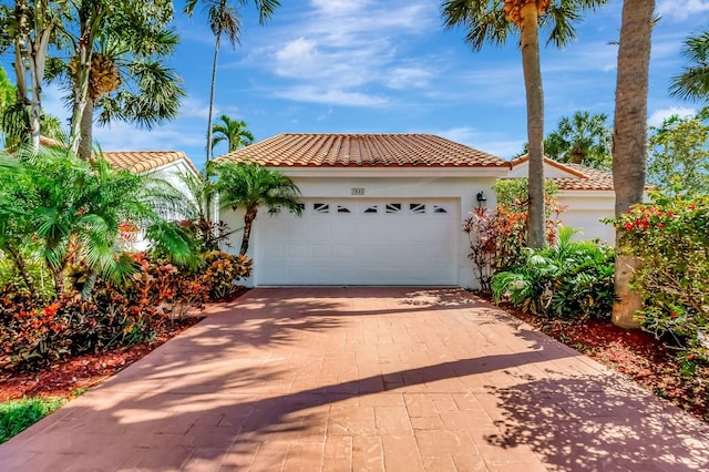 mediterranean / spanish-style home featuring a garage