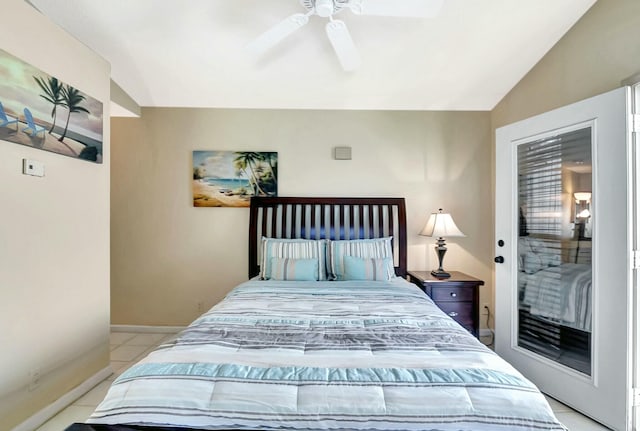 tiled bedroom with lofted ceiling and ceiling fan