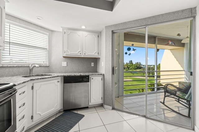 kitchen featuring a sink, plenty of natural light, appliances with stainless steel finishes, and white cabinetry