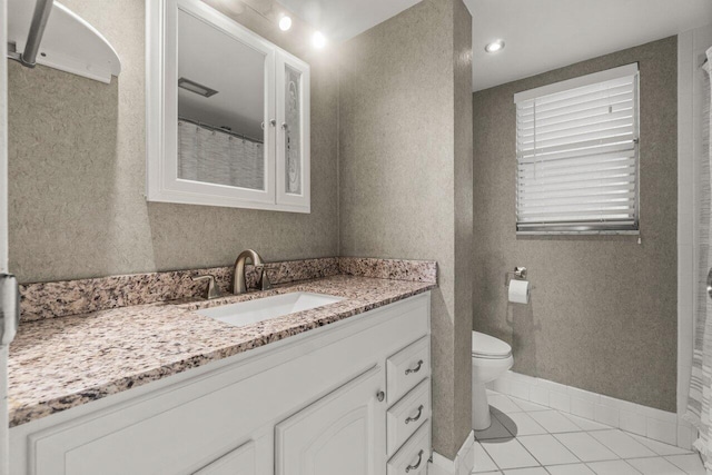 bathroom with vanity, a shower with curtain, baseboards, tile patterned flooring, and toilet