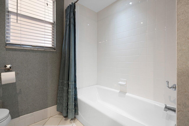 bathroom with shower / bath combination with curtain, tile patterned floors, and toilet