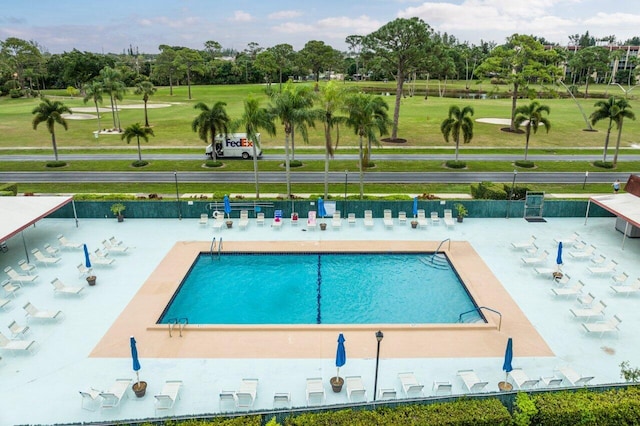 community pool featuring a lawn