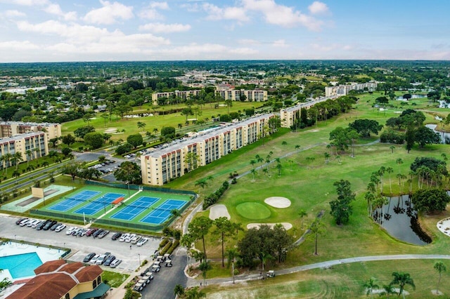 birds eye view of property featuring view of golf course and a water view