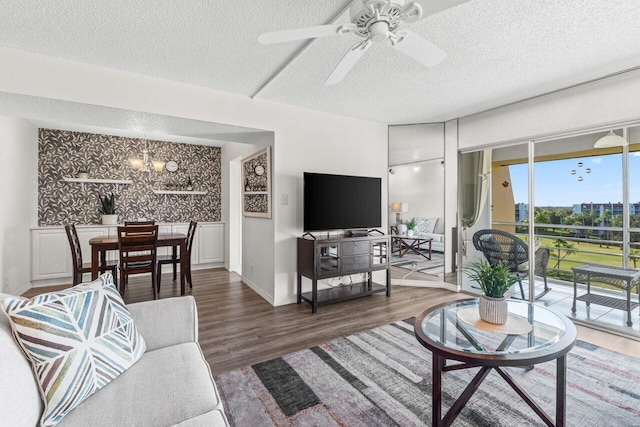 living room featuring ceiling fan, dark hardwood / wood-style floors, and a textured ceiling