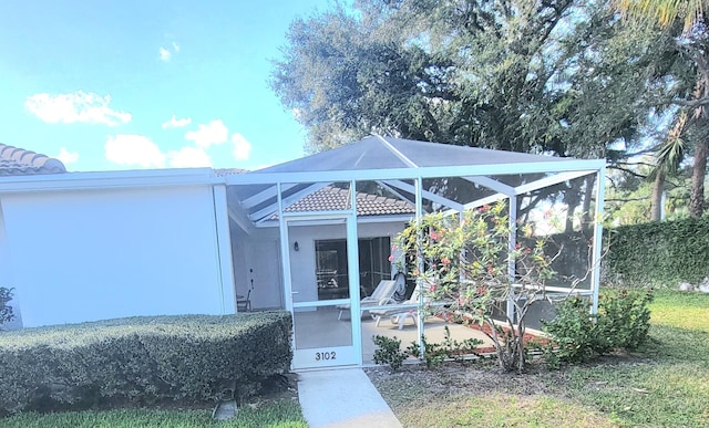 view of exterior entry featuring a patio