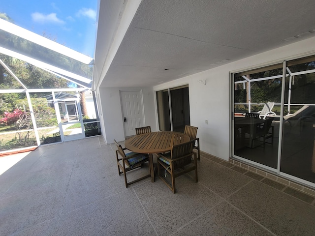 view of patio with glass enclosure