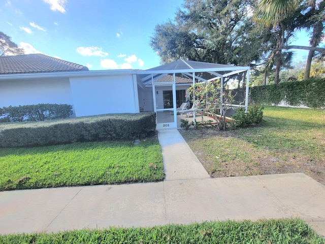 view of front facade with a lanai and a front lawn