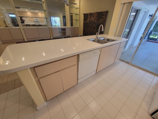 kitchen with ceiling fan, white dishwasher, and sink