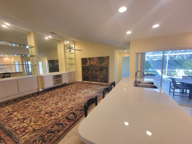 kitchen with ceiling fan, sink, and light tile patterned floors