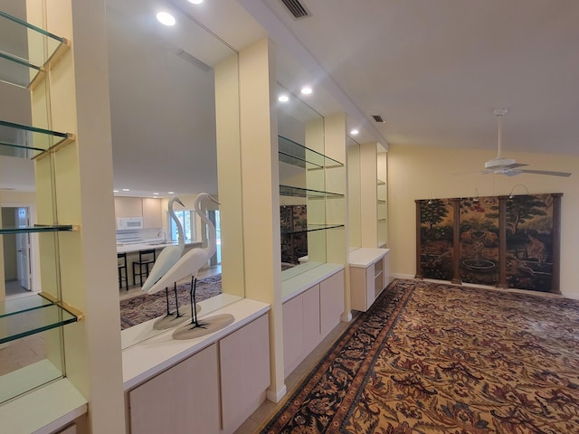 interior space with sink and ceiling fan