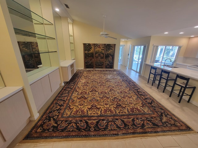 hallway featuring lofted ceiling and sink