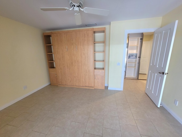 unfurnished bedroom featuring light tile patterned floors and ceiling fan