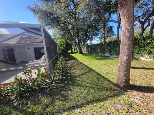 view of yard with glass enclosure