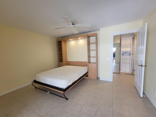 bedroom with ceiling fan and light tile patterned floors