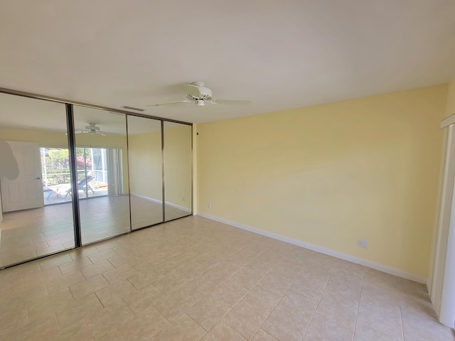 unfurnished bedroom featuring a wall of windows, ceiling fan, and light tile patterned flooring