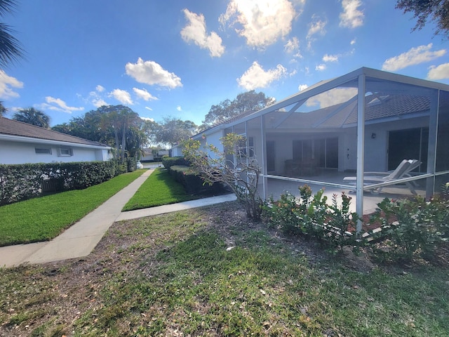 view of yard with a pool, a lanai, and a patio area