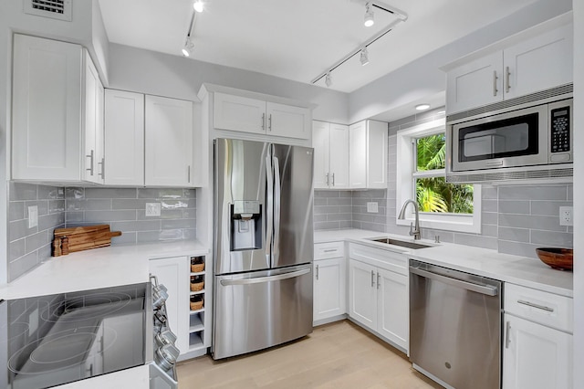 kitchen featuring white cabinetry, appliances with stainless steel finishes, and sink